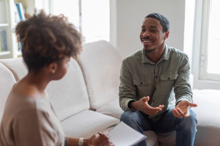 Cheerful man speaking to a therapist
