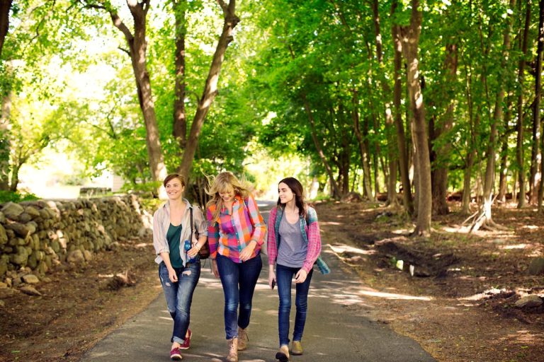 Three young women walking in park